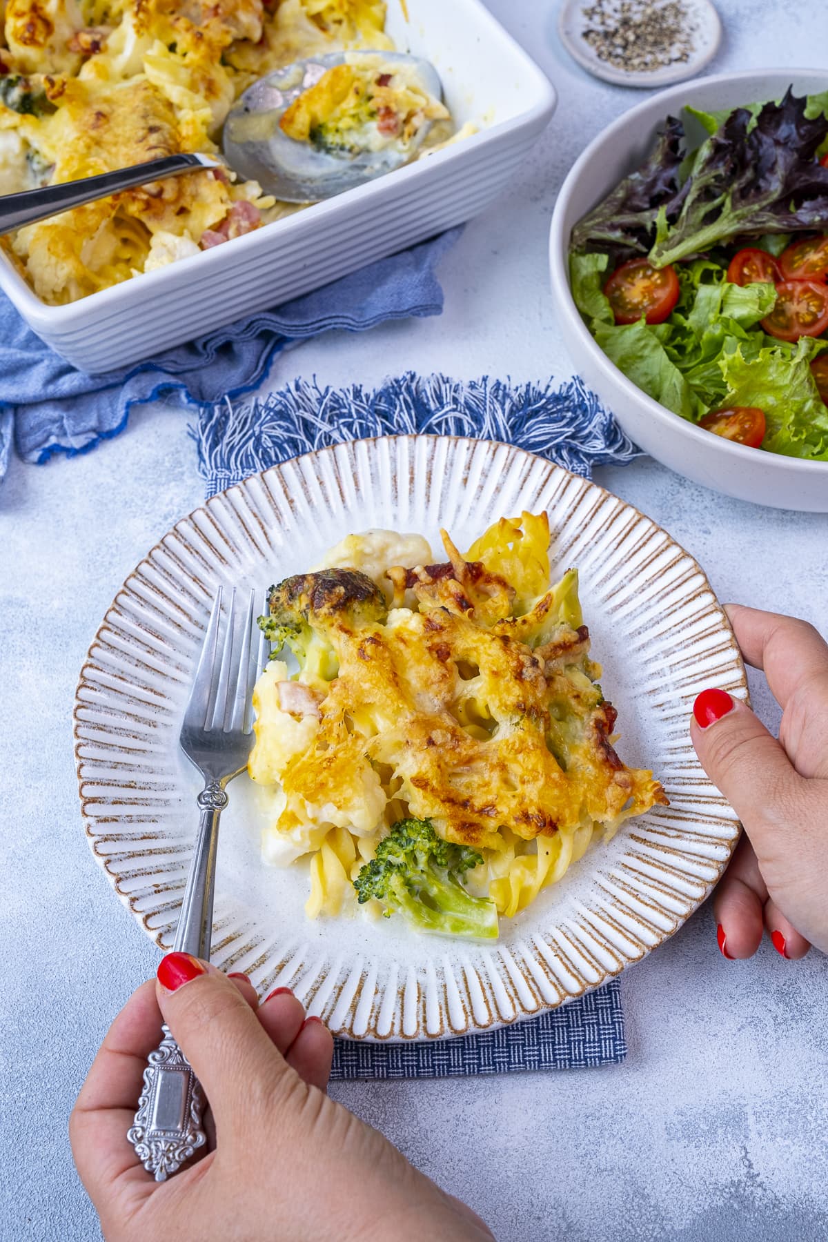 One portion of Cauliflower, Broccoli and Bacon Pasta Bake on a plate