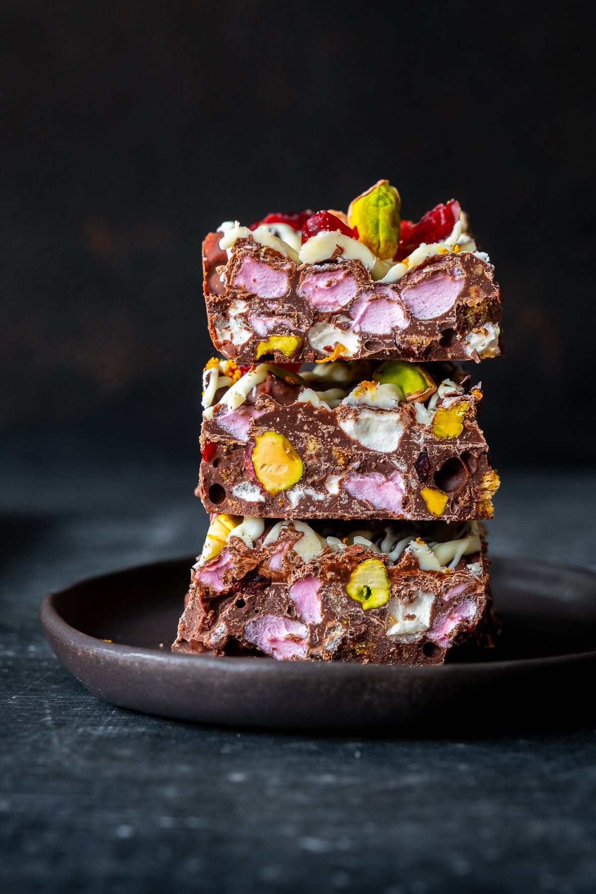 3 squares of Christmas Rocky Road in a pile on a plate