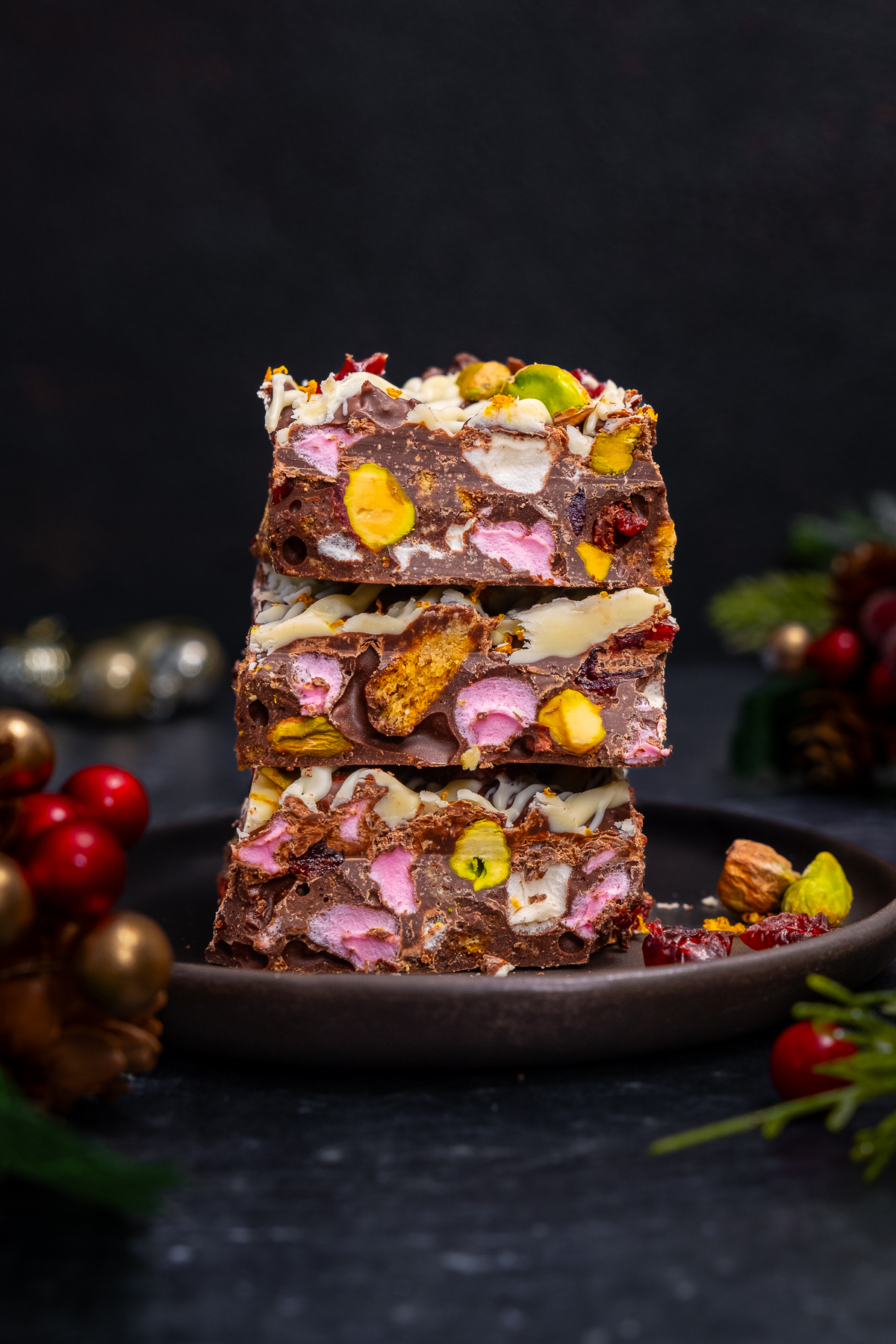 3 squares of Christmas Rocky Road in a pile on a plate