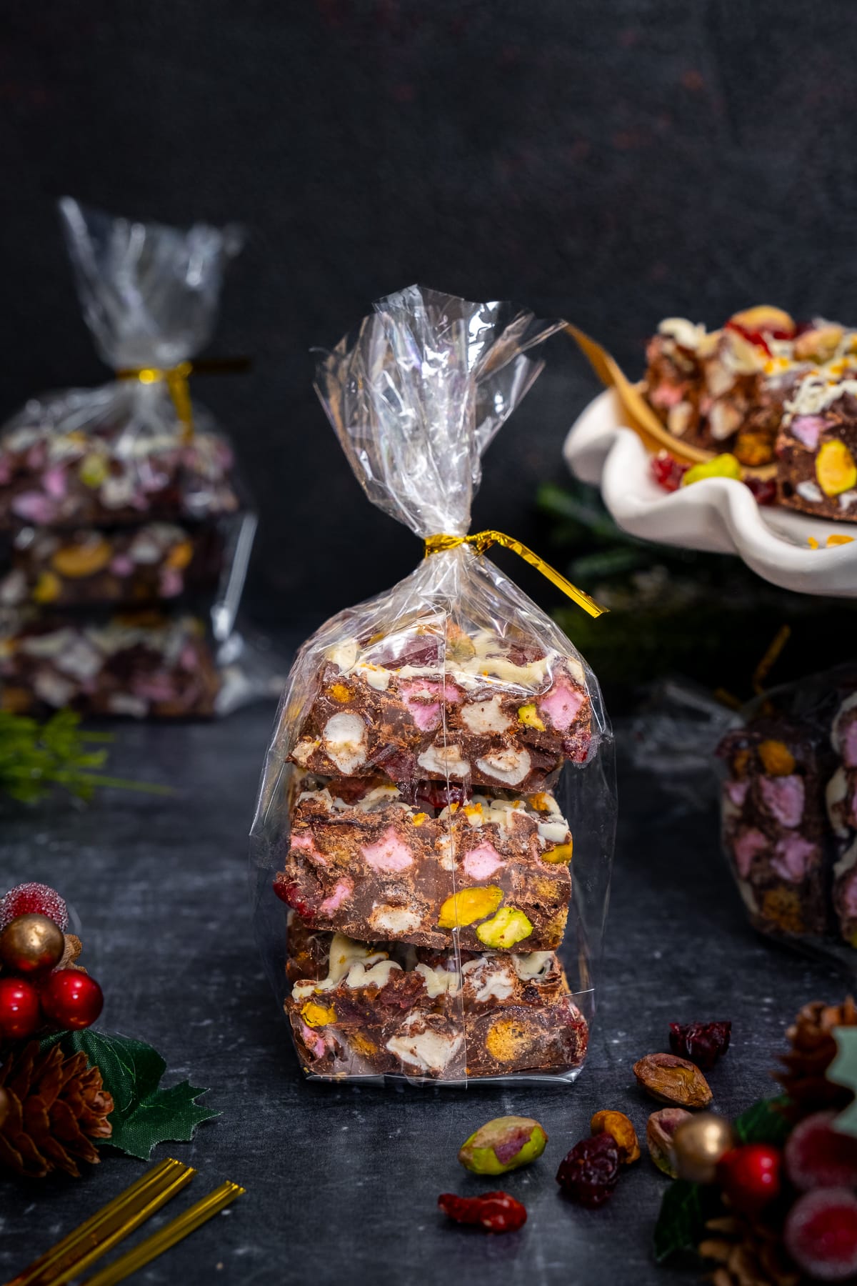 Christmas Rocky Road packaged as a gift in a cellophane bag tied with a gold ribbon