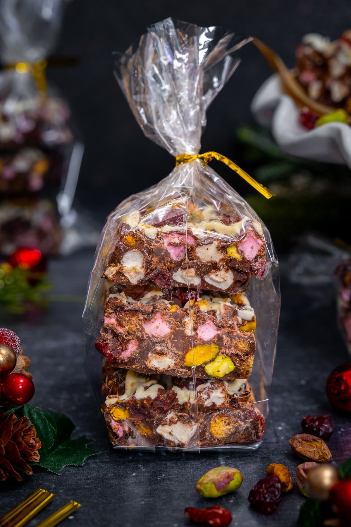 Christmas Rocky Road packaged as a gift in a cellophane bag tied with a gold ribbon