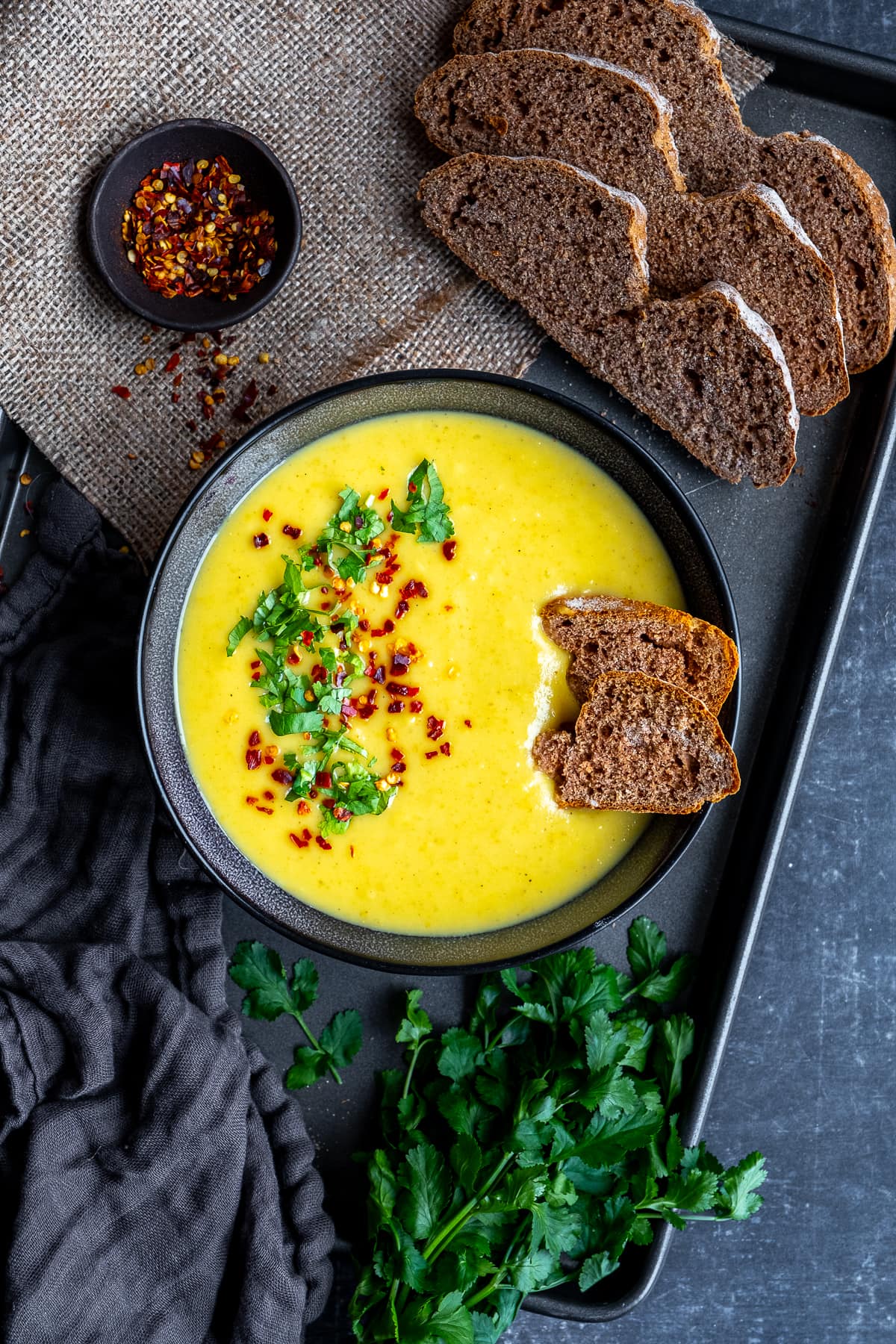 Overhead shot of 1 bowl of Curried Parsnip Soup with Buckwheat Soda Bread