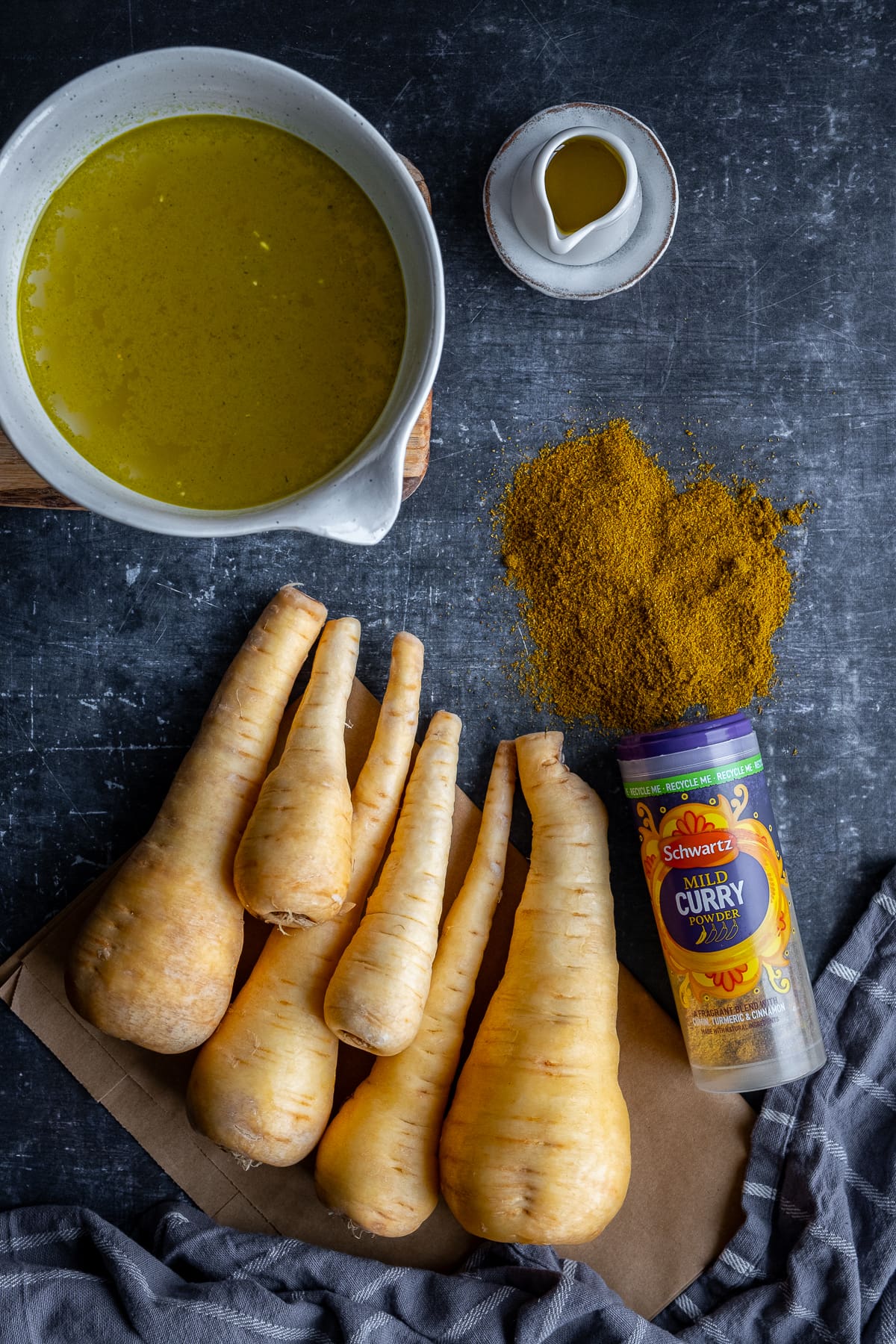 Ingredients shot for Curried Parsnip Soup showing parsnips, vegetable stock and a jar of Schwartz Mild Curry Powder 