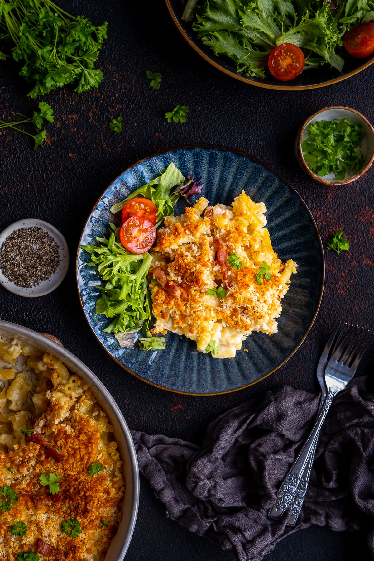 Overhead shot of Easy Bacon Macaroni Cheese on a plate with a side salad of lettuce and tomatoes