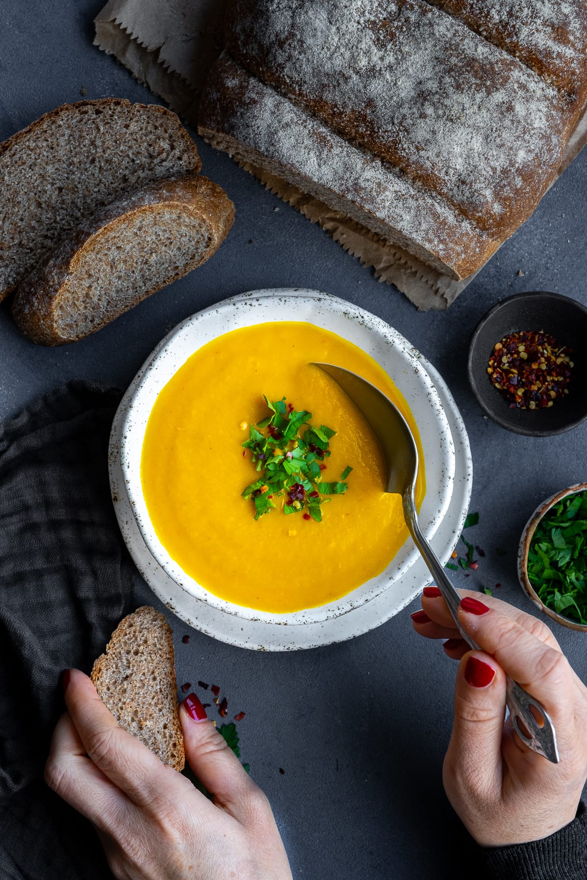 Overhead shot of 1 bowl of Easy Carrot and Butternut Squash Soup with Super Simple Wholemeal Bread.