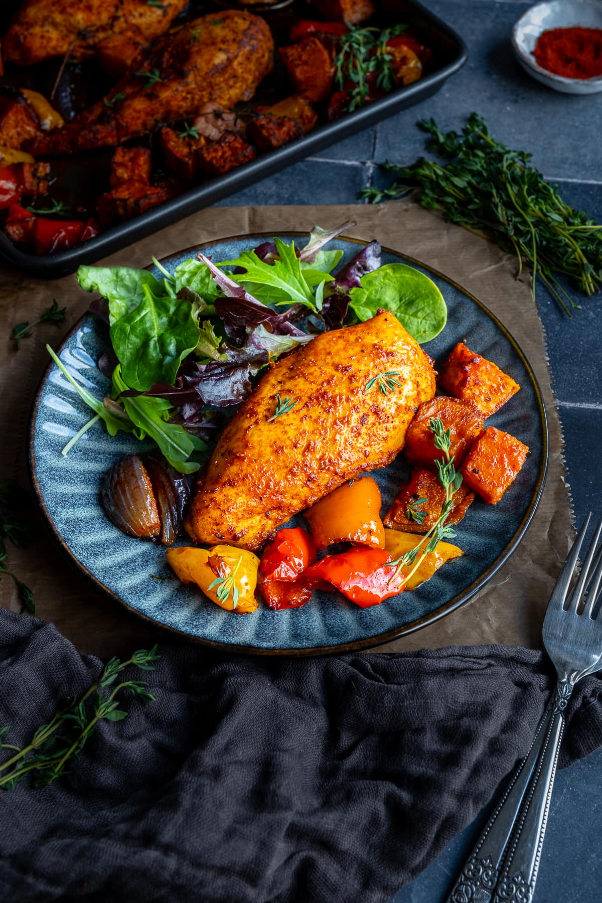 Easy Chicken Breast Traybake on a plate with a green side salad