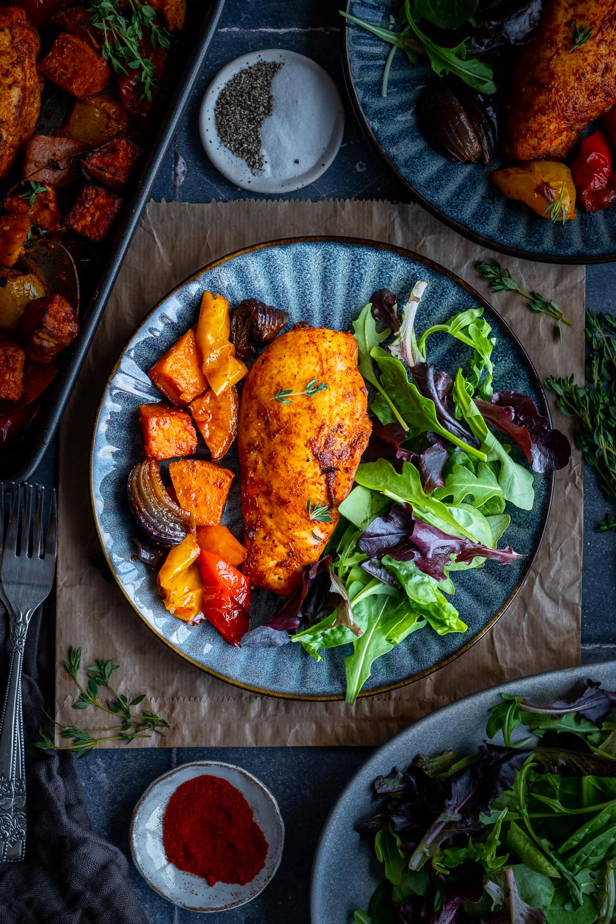 Overhead shot of Easy Chicken Breast Traybake on a plate with a green side salad