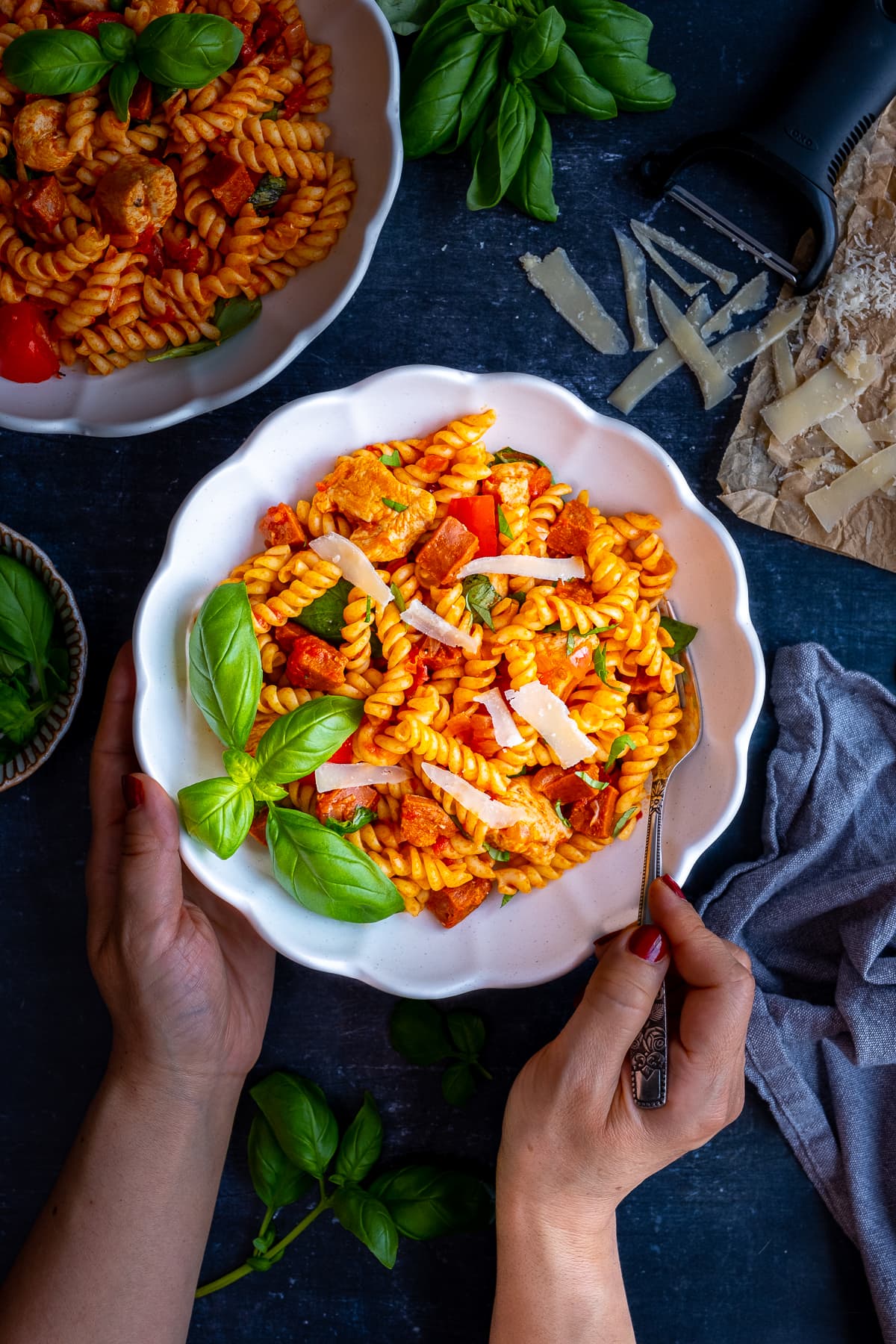 Overhead shot of Easy Chicken and Chorizo Pasta in a bowl, surrounded by the ingredients