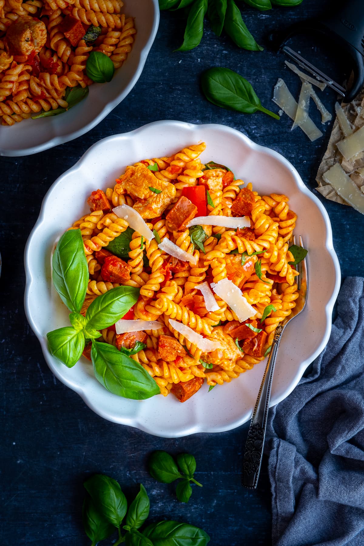 Overhead shot of Easy Chicken and Chorizo Pasta in a bowl, surrounded by the ingredients