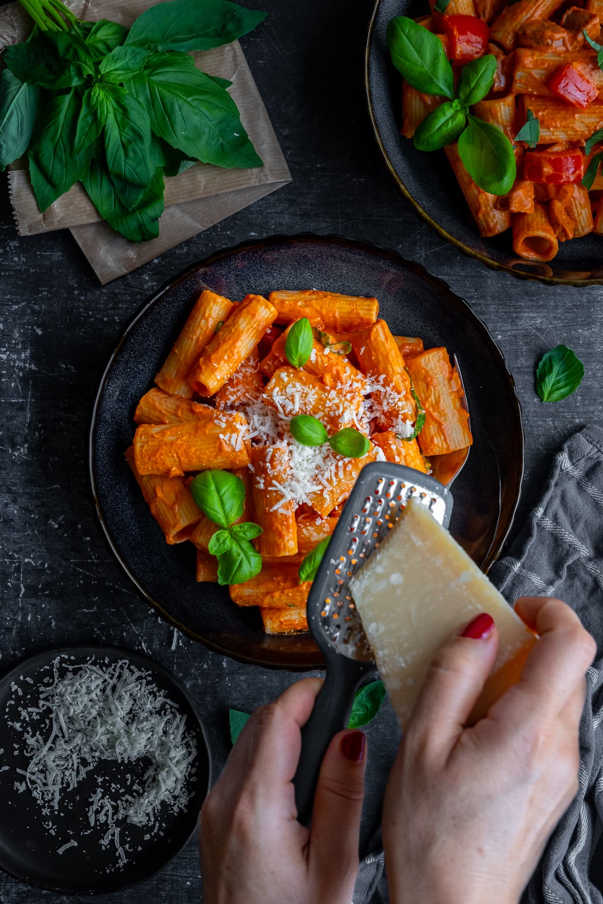 Overhead shot of parmesan being grated over Easy Creamy Chorizo Pasta 