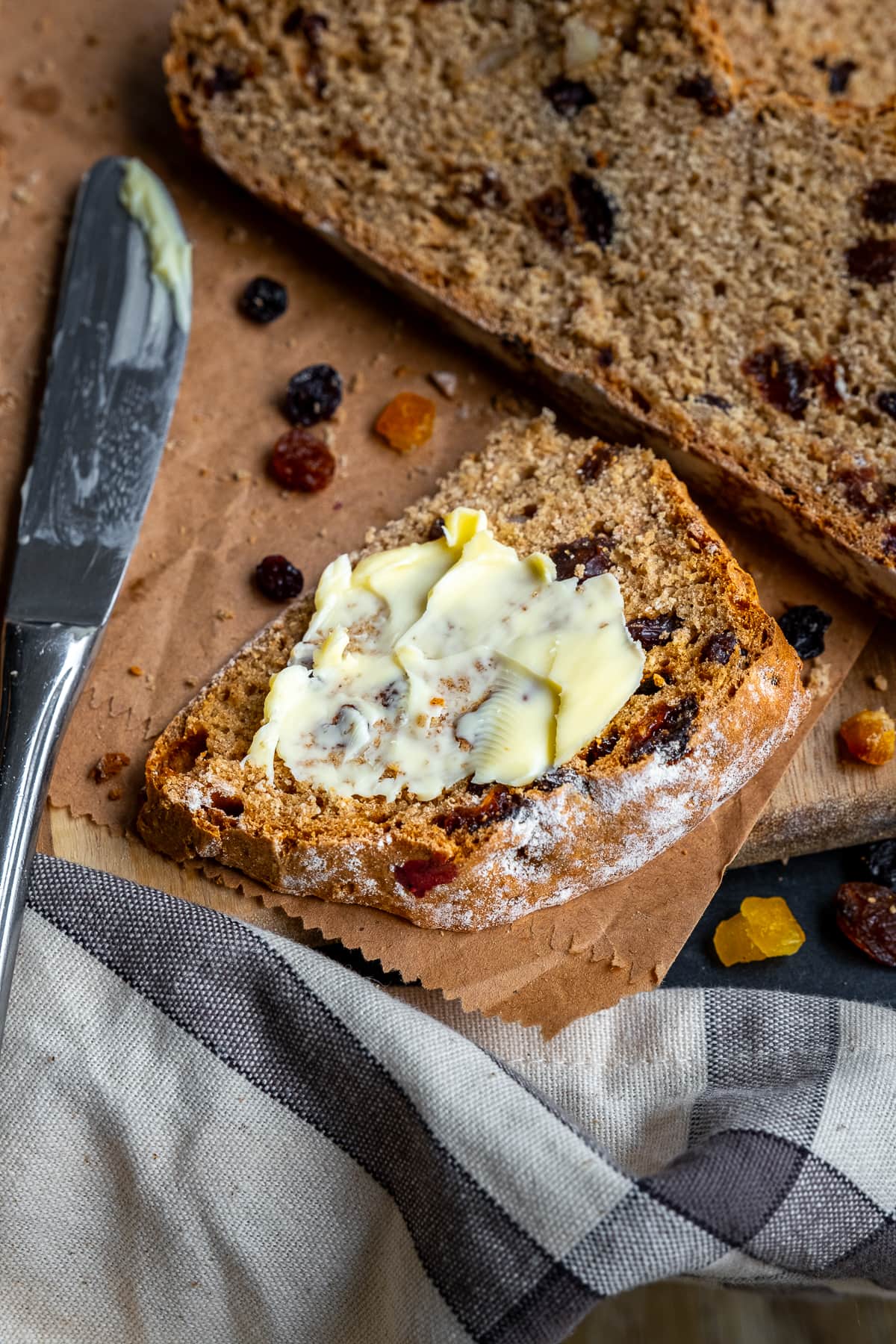 Closeup of Easy Fruit Soda Bread spread with butter.