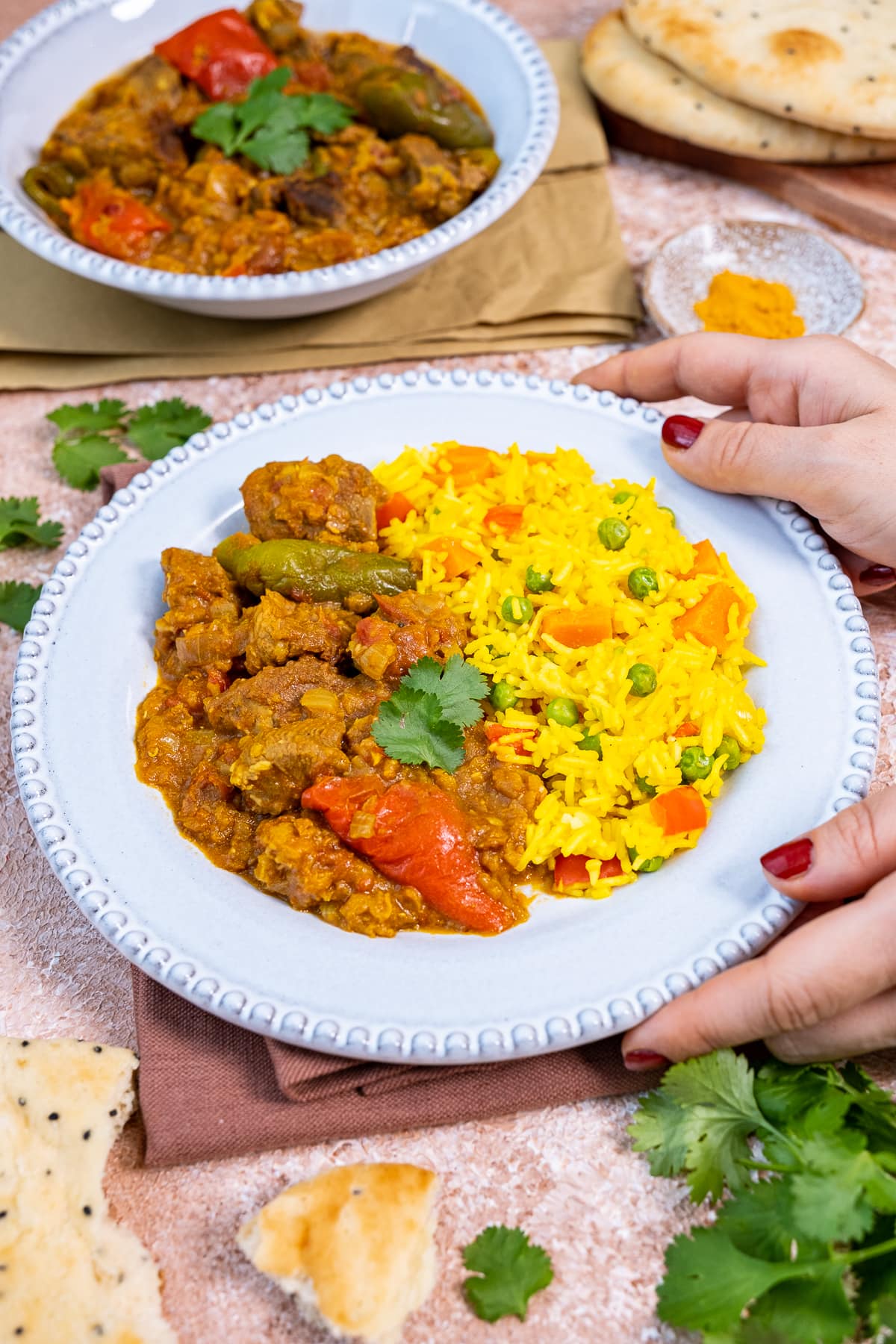 Easy Lamb Dhansak on a plate held by female hands