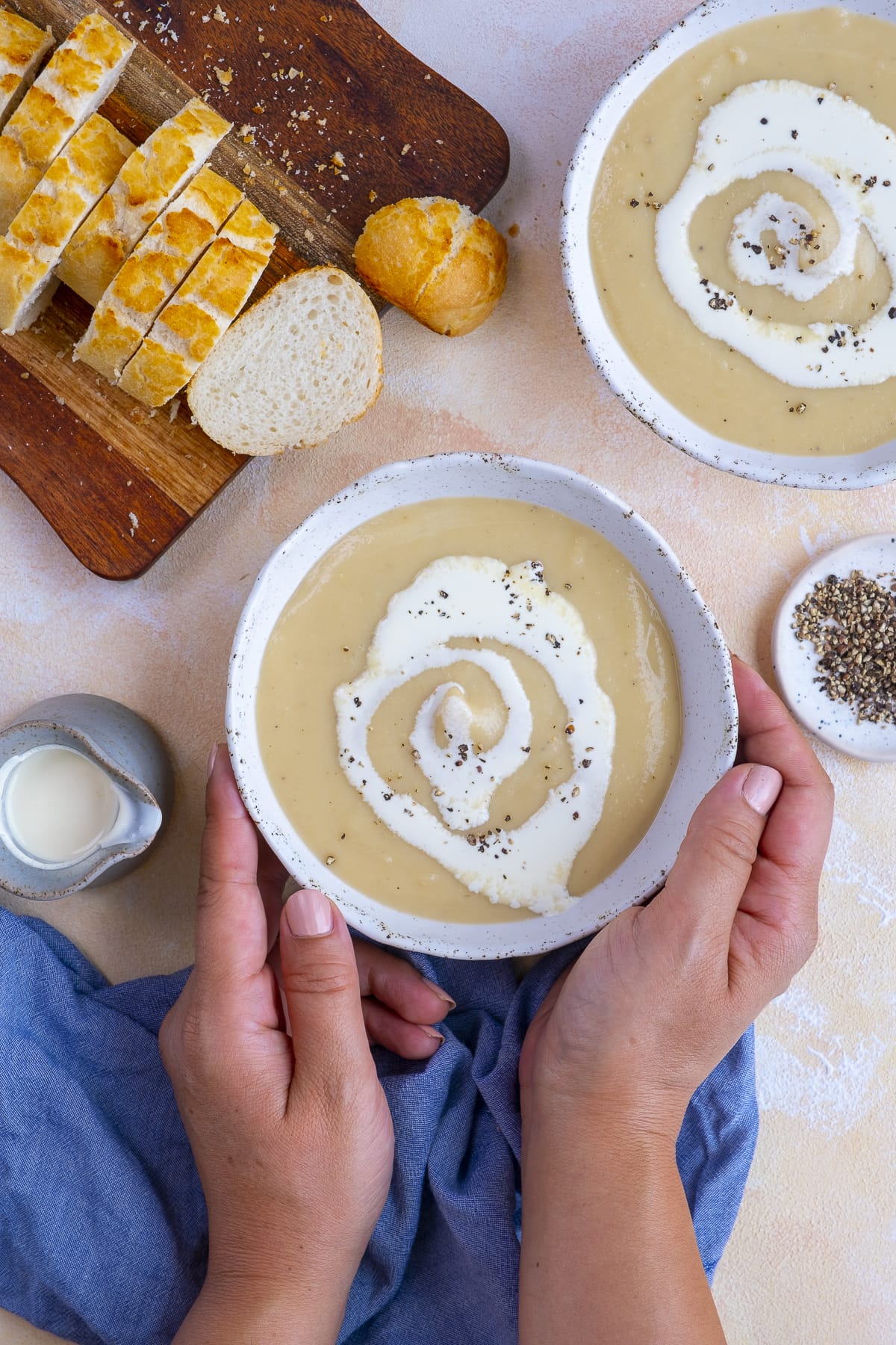 Easy Peasy Parsnip Soup in two bowls, with sliced french bread