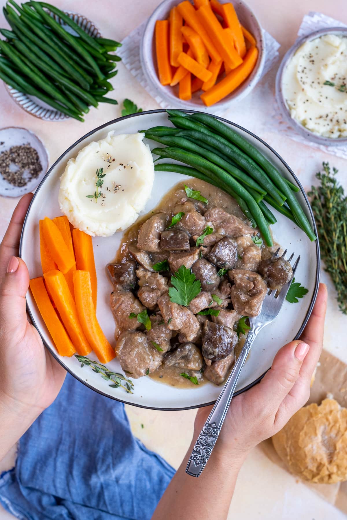 A plate of Easy Peasy Lamb Stew being held up to the camera.