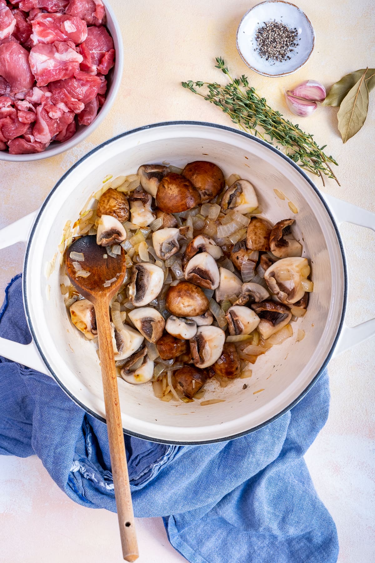 Mushrooms being fried in a pan for Easy Peasy Lamb Stew