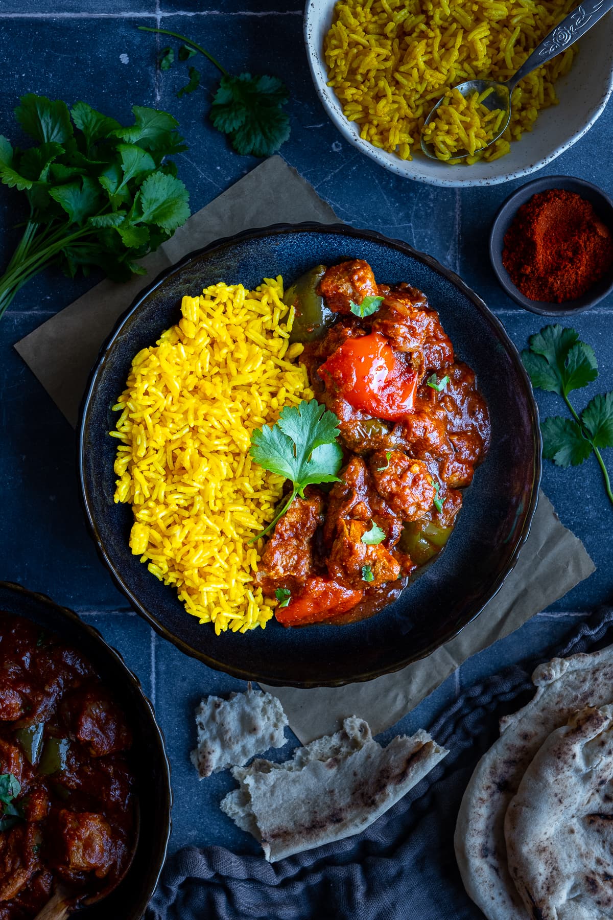 Overhead shot of Easy Peasy Pork Curry in a bowl with yellow pilau rice