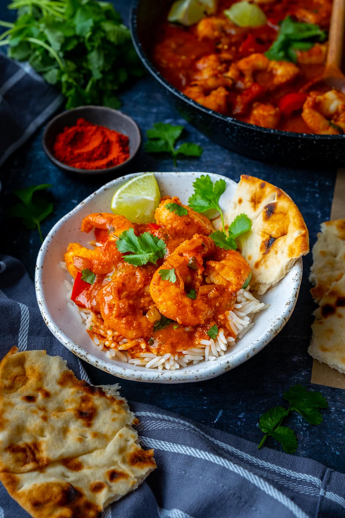 Easy Prawn Tikka Masala in a bowl with rice and naan bread