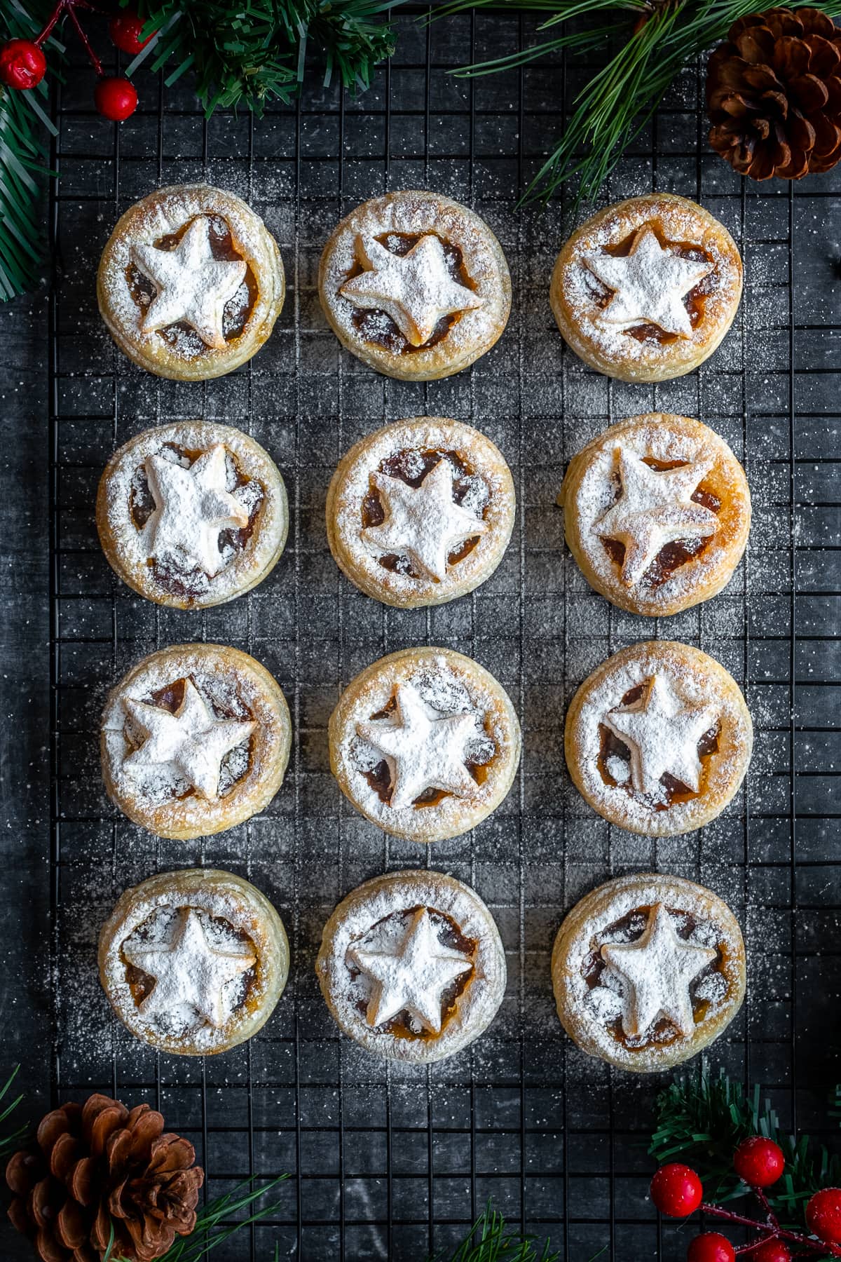 12 Easy Puff Pastry Mince Pies dusted with icing sugar on a cooling rack