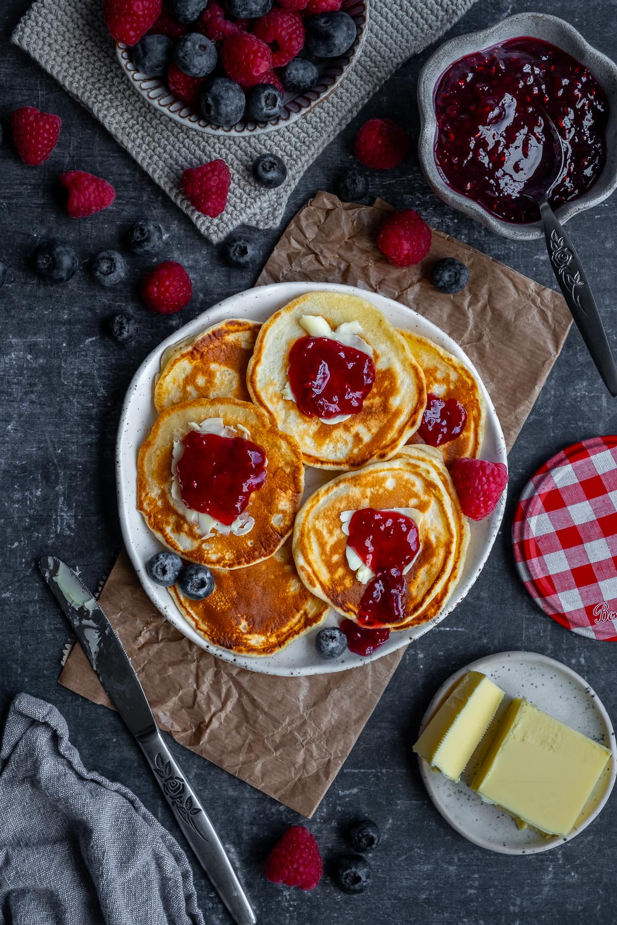 Easy Scotch Pancakes topped with jam and butter.