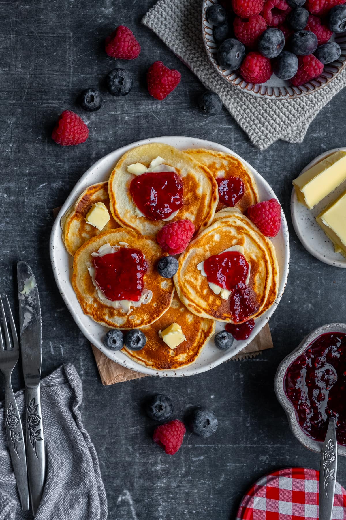 Easy Scotch Pancakes topped with jam and butter.