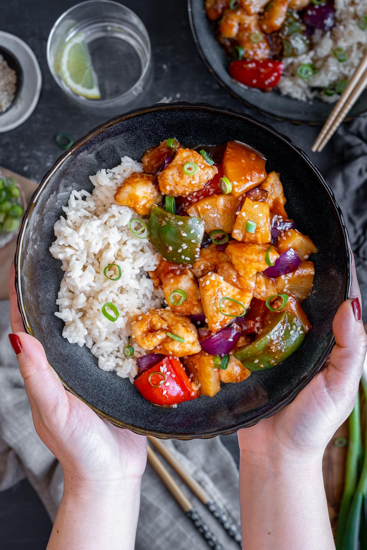 Bowl of Easy Sweet and Sour Chicken being held up to the camera