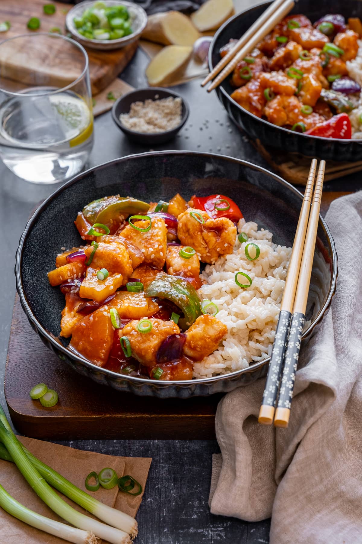 Easy Sweet and Sour Chicken in a bowl, with chopsticks