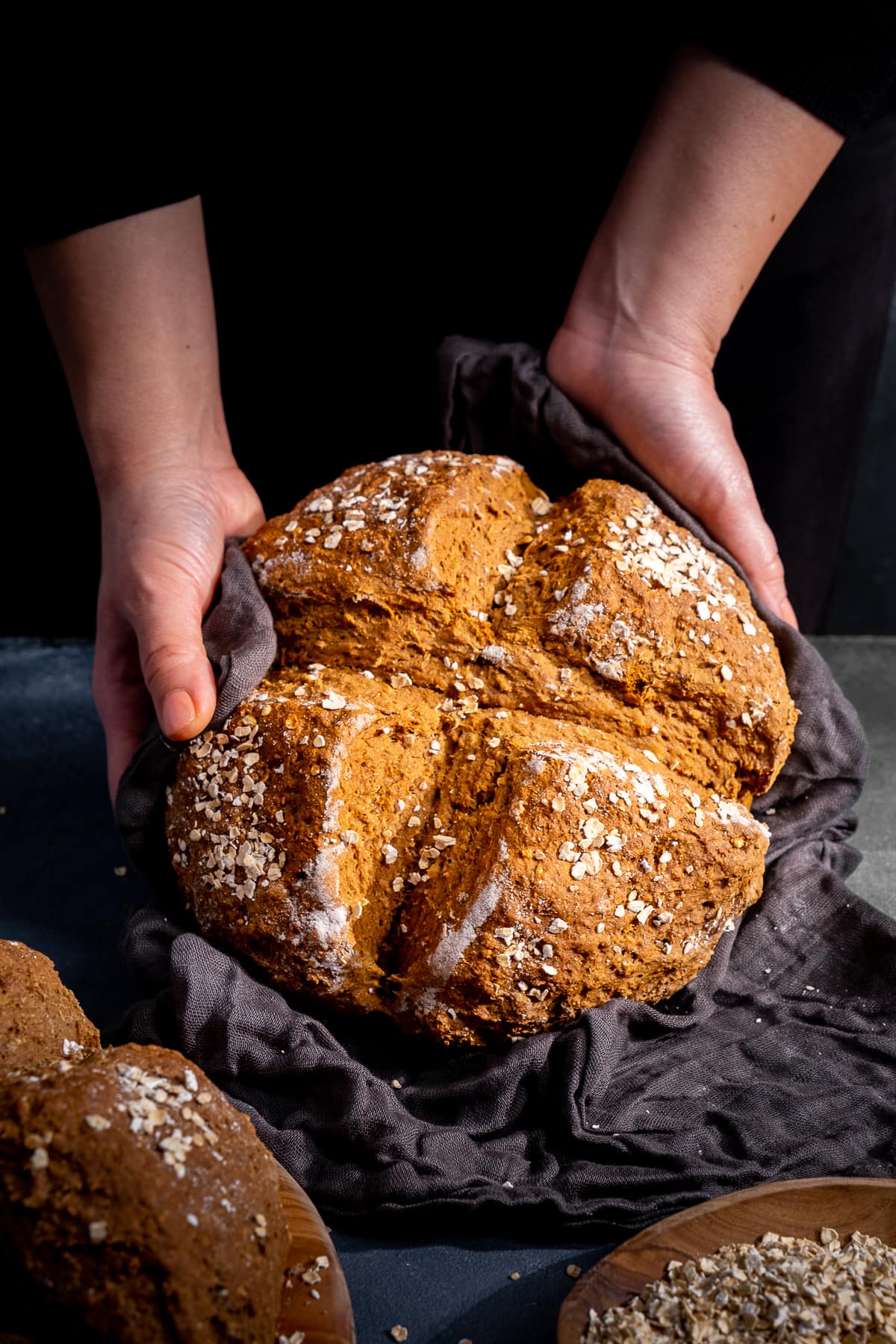 Guinness and Treacle Soda Bread being held up to the camera