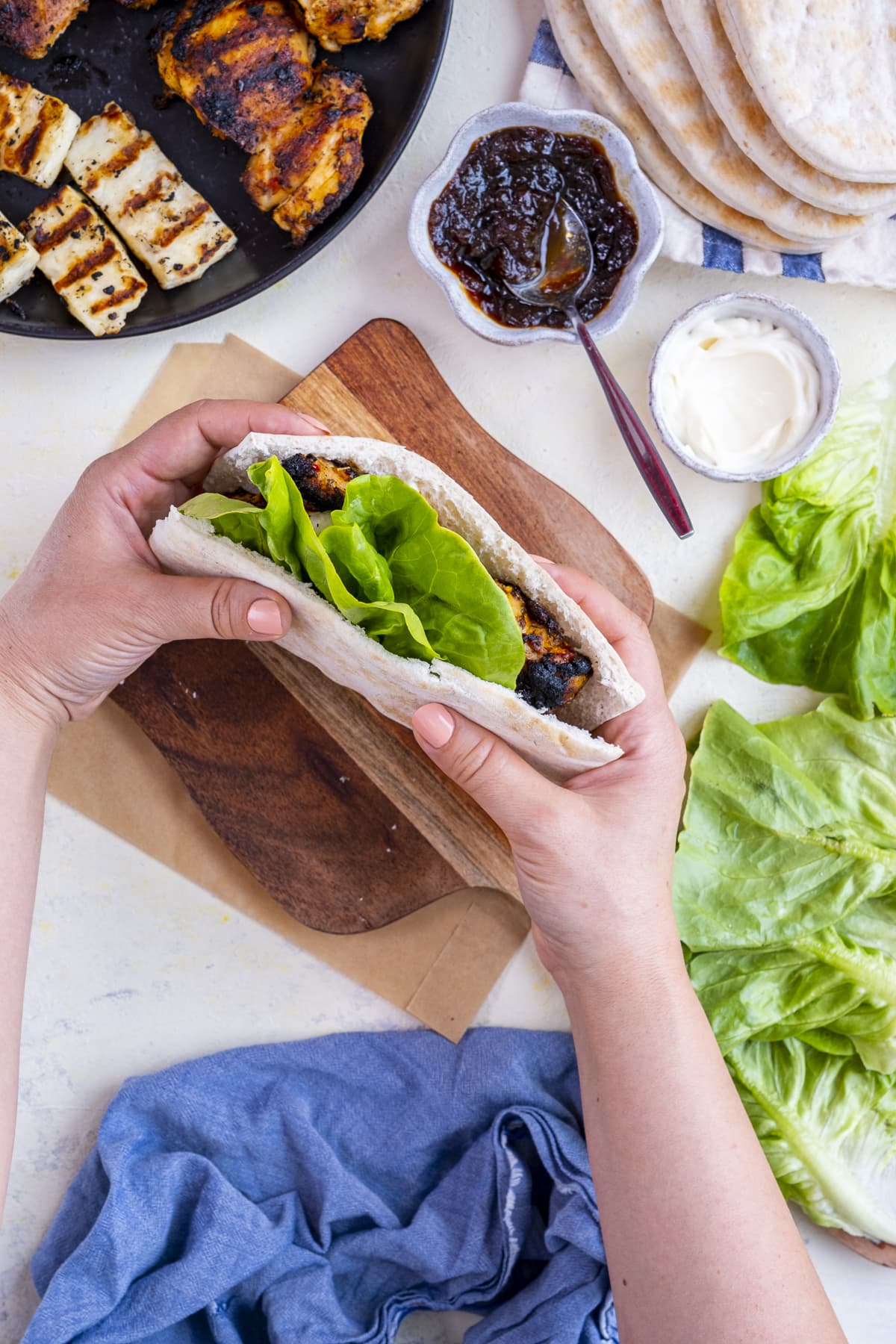 Homemade Nando's Fino Pitta being held up to the camera by two female hands