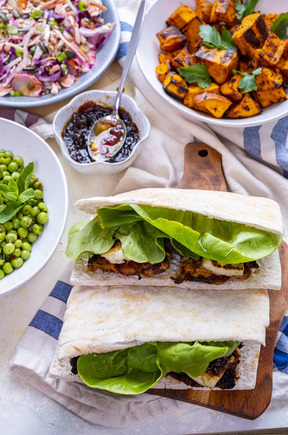 2 Homemade Nando's Fino Pitta on a board, surrounded by various Nando's style sides