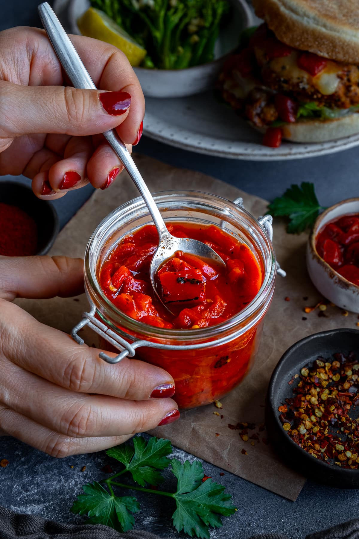 Homemade Nandos Smoky Red Pepper Chutney in a jam jar with a spoon