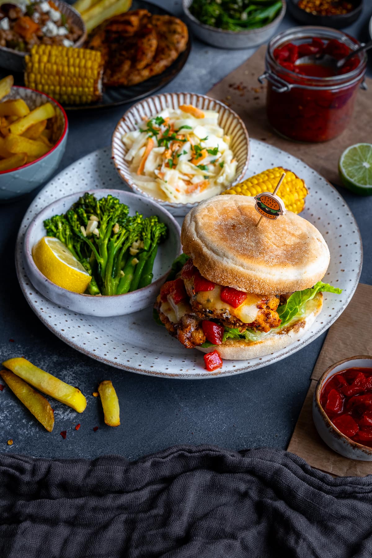 Homemade Nandos Sunset Burgers on a plate with Tenderstem broccoli and coleslaw