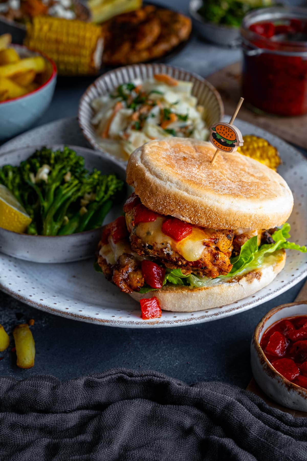 Homemade Nandos Sunset Burgers on a plate with Tenderstem broccoli and coleslaw