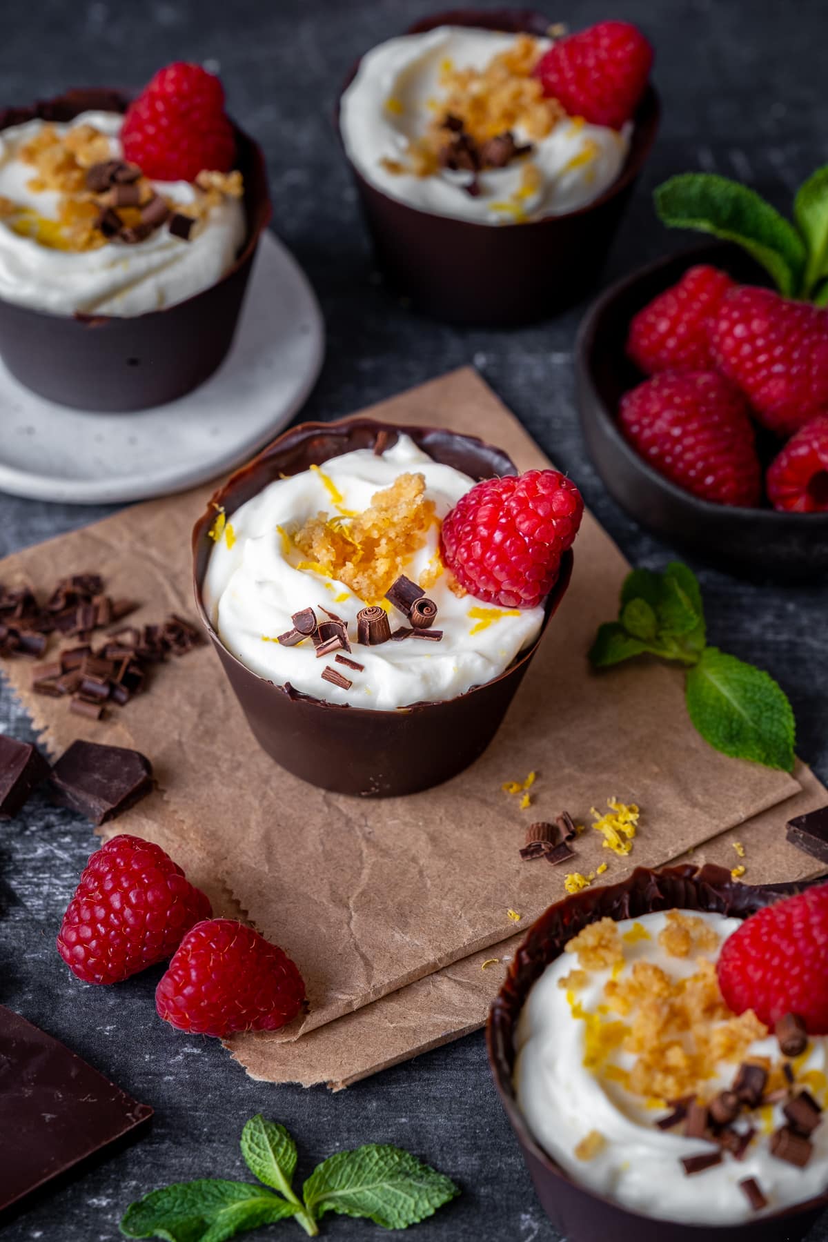 4 Lemon Cheesecake Chocolate Cups, shown with fresh raspberries and mint