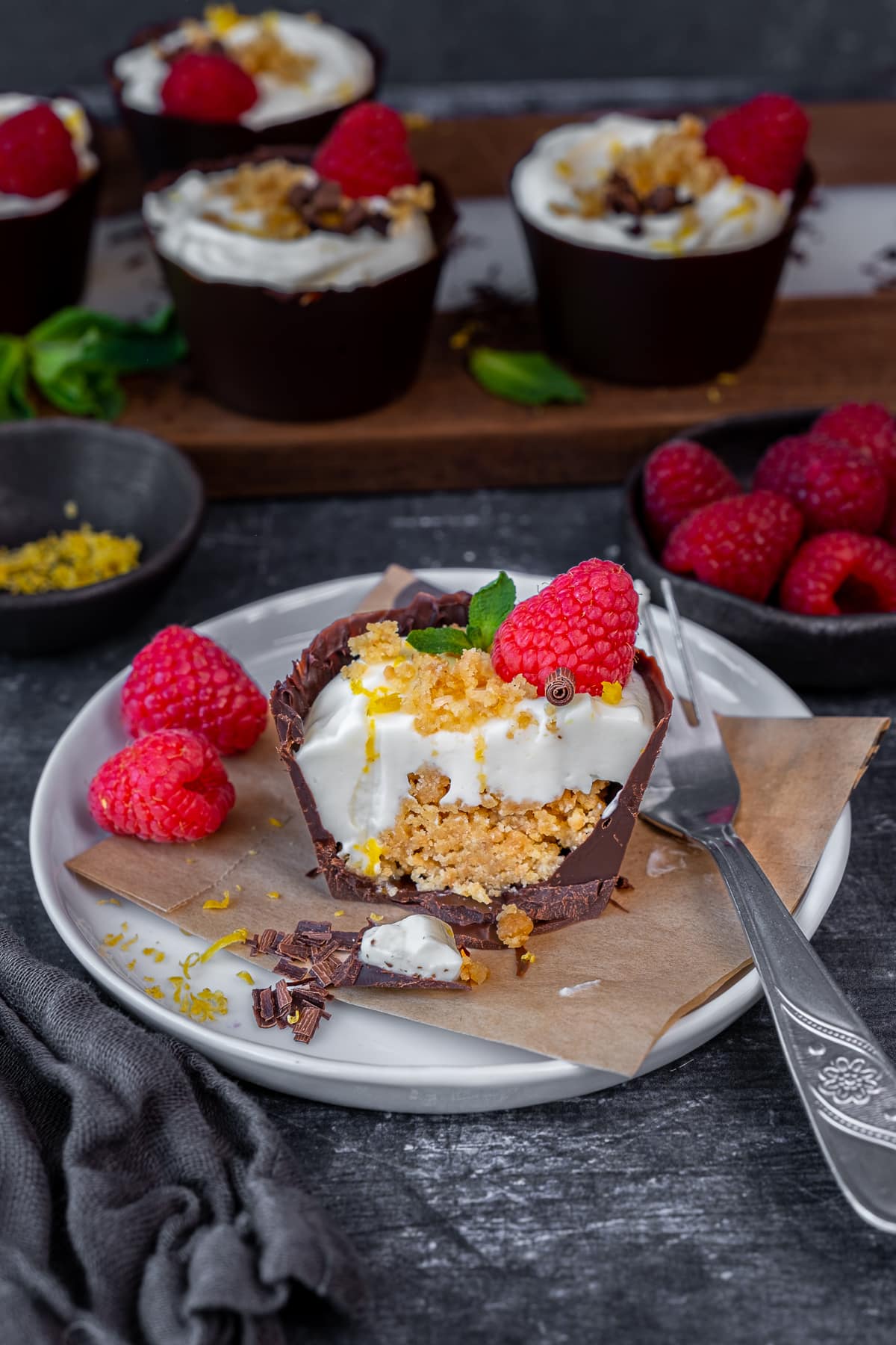 Lemon Cheesecake Chocolate Cups cut open to reveal a cross section