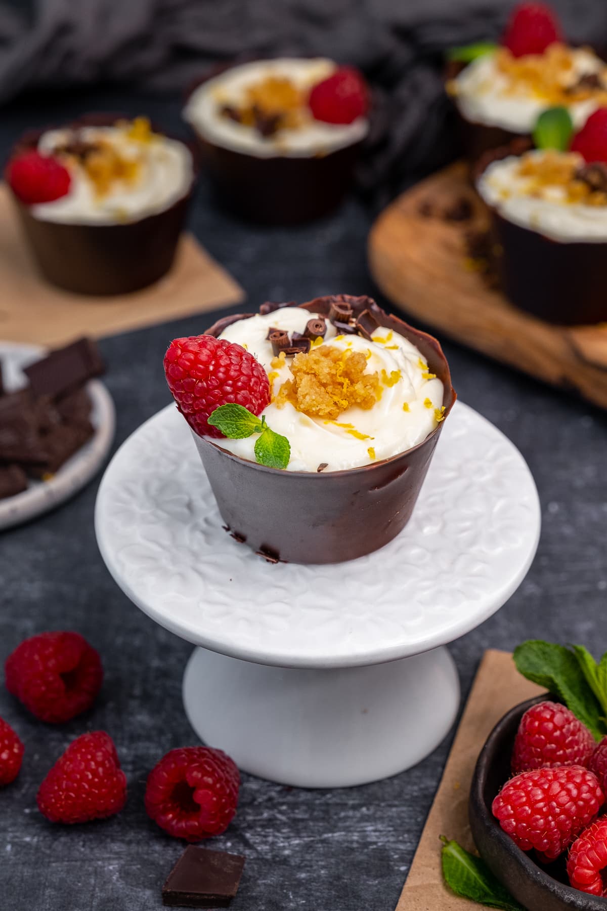 One Lemon Cheesecake Chocolate Cups on a mini cakestand