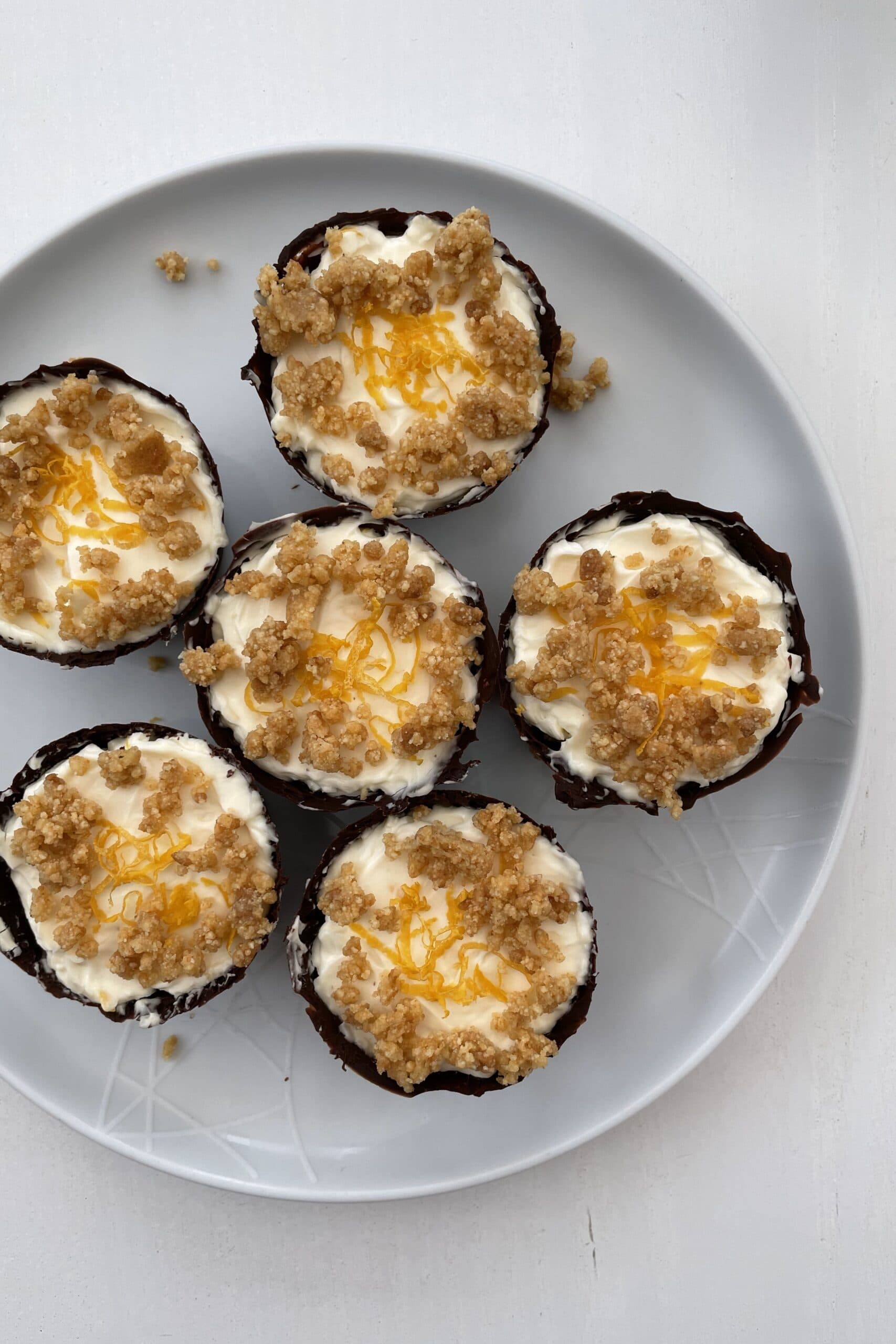 Original version of Lemon Cheesecake Chocolate Cups with only biscuit crumbs and lemon zest as decoration