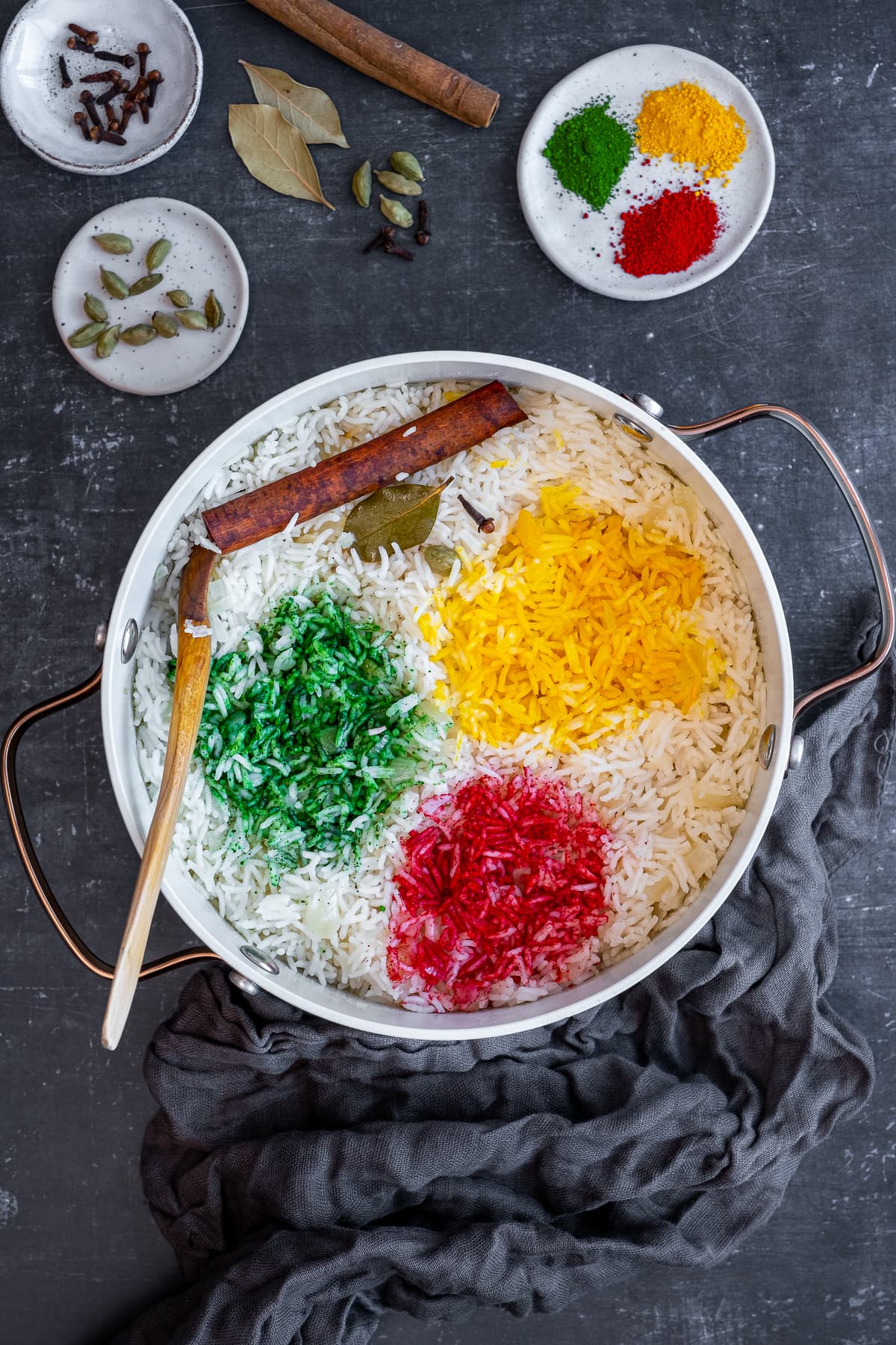 Overhead shot of Multicoloured Pilau Rice showing the 3 small sections of rice coloured with yellow, green and red edible coloured powders