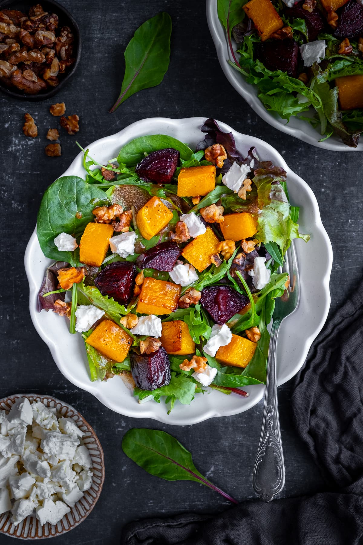 Overhead shot of Roasted Butternut Squash and Beetroot Salad with Feta and Walnuts in a white bowl