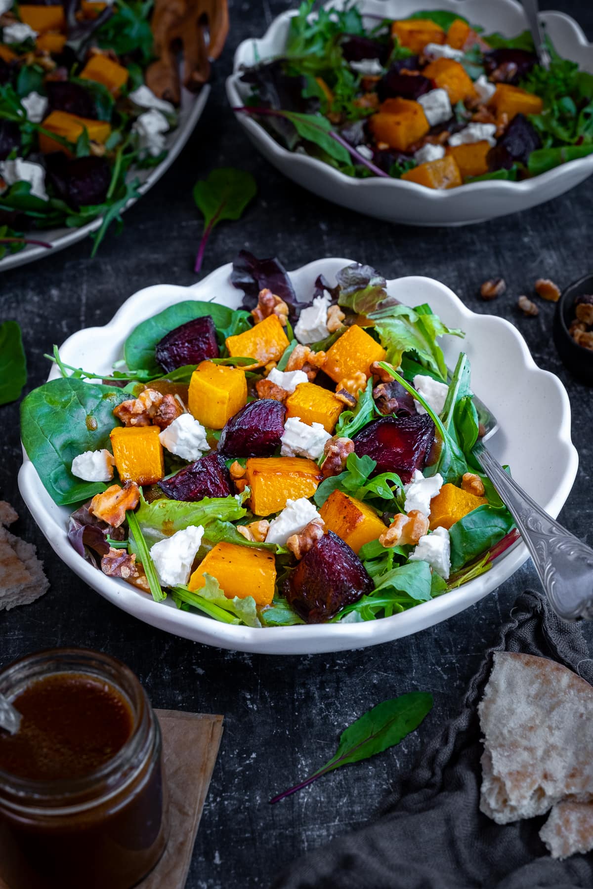 Roasted Butternut Squash and Beetroot Salad with Feta and Walnuts in a white bowl