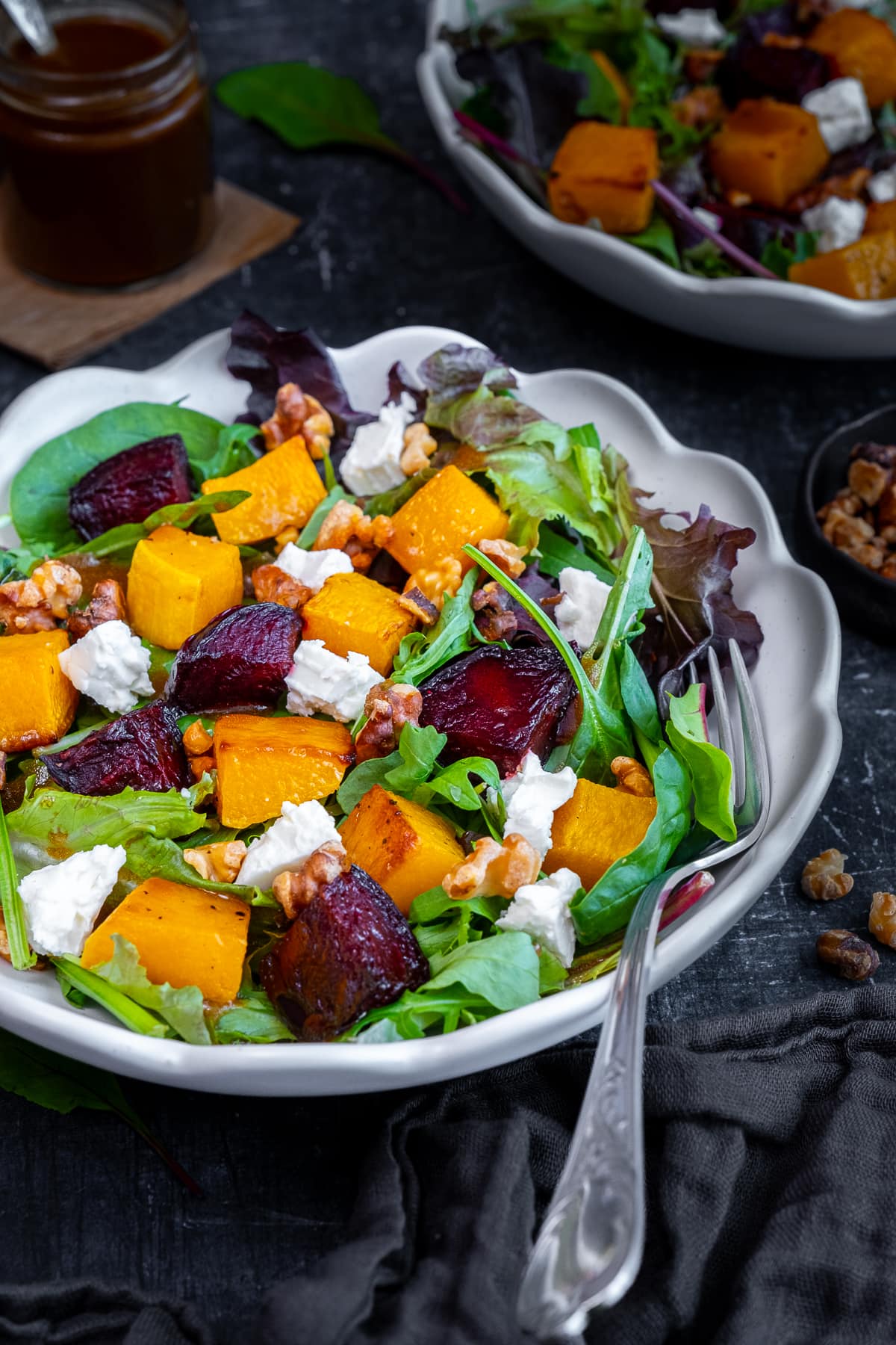 Roasted Butternut Squash and Beetroot Salad with Feta and Walnuts in a bowl with a fork