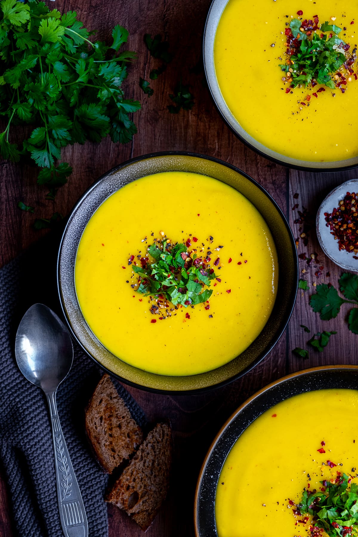 Overhead shot of 3 bowls of Spicy Parsnip Soup