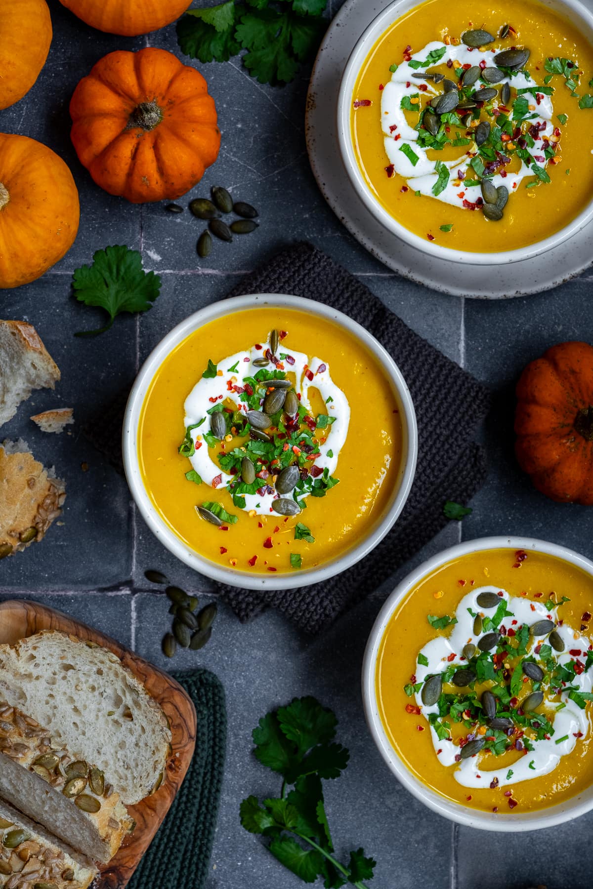 Overhead shot of 3 bowls of Spicy Pumpkin Soup