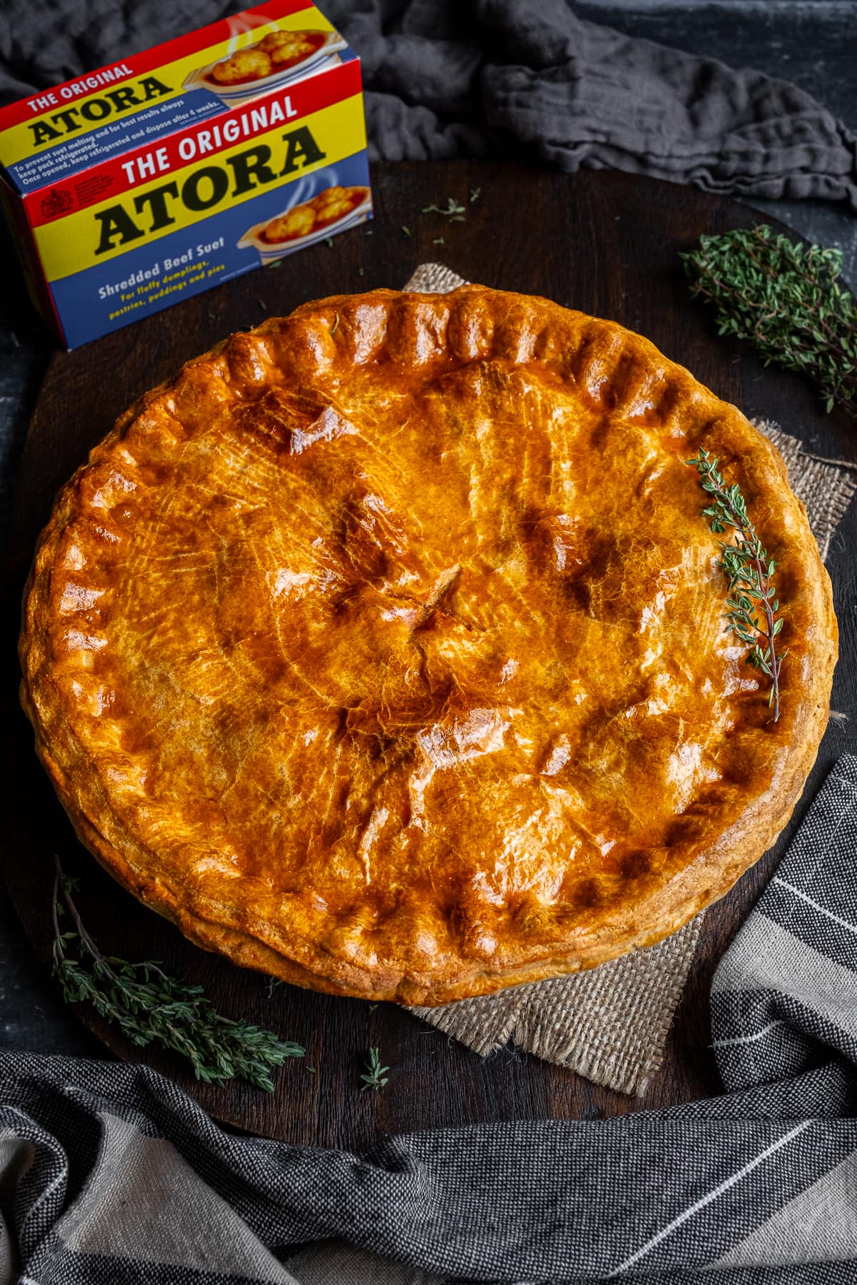 Traditional Suet Crust Beef Pie with a packet of Atora Beef Suet in the background.