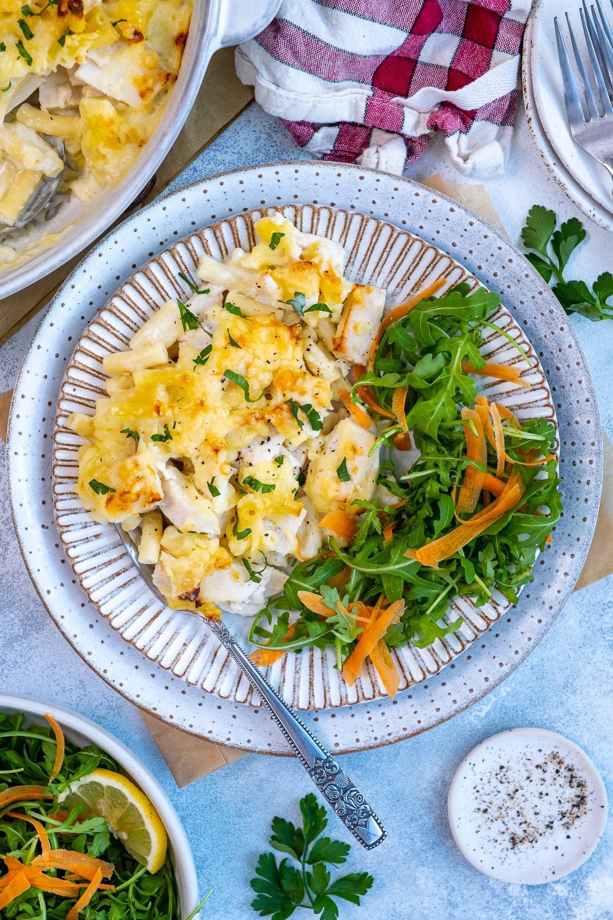 Overhead shot of Turkey Macaroni Cheese on a plate with a side salad