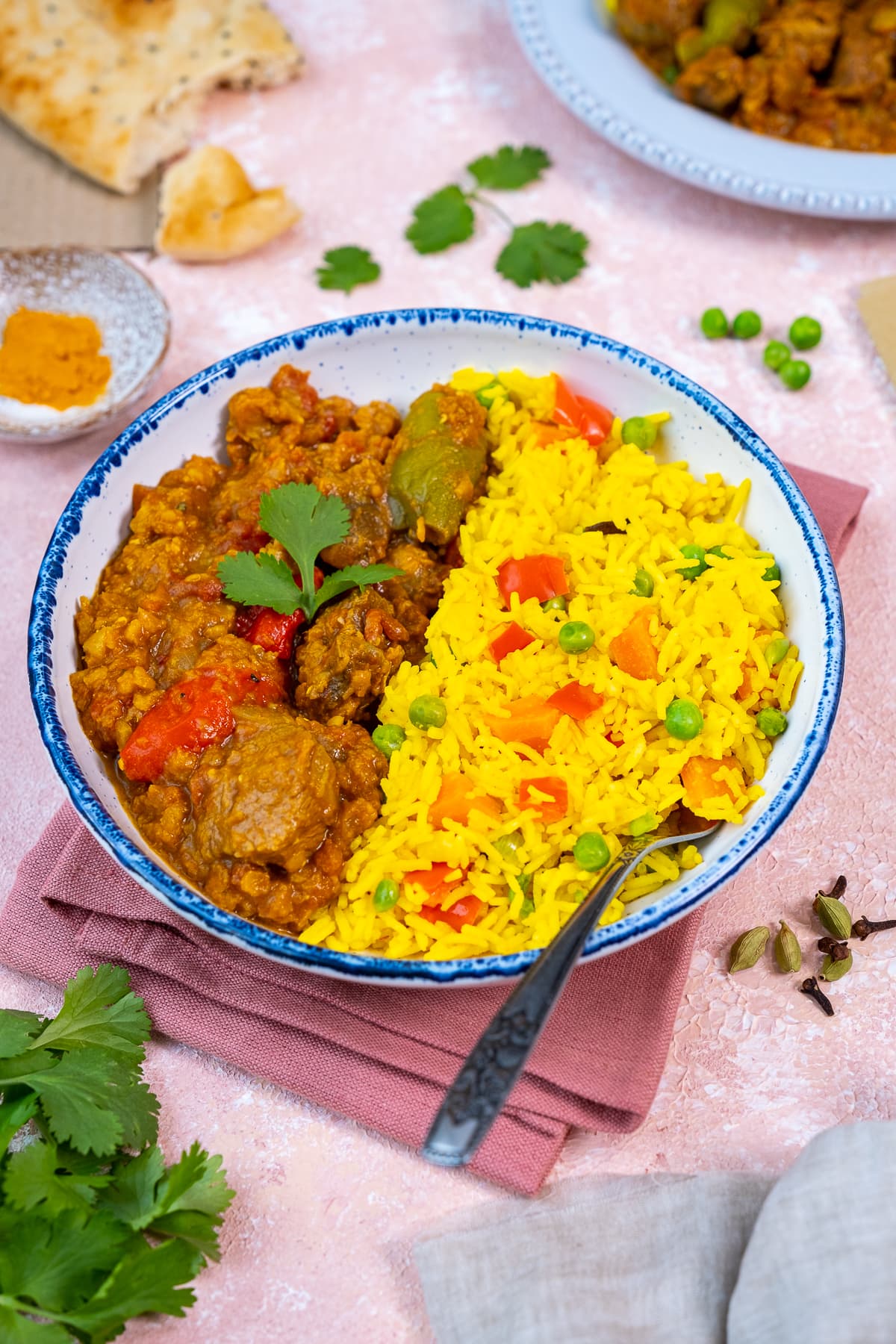 Vegetable Pilau Rice in a bowl with Easy Lamb Dhansak